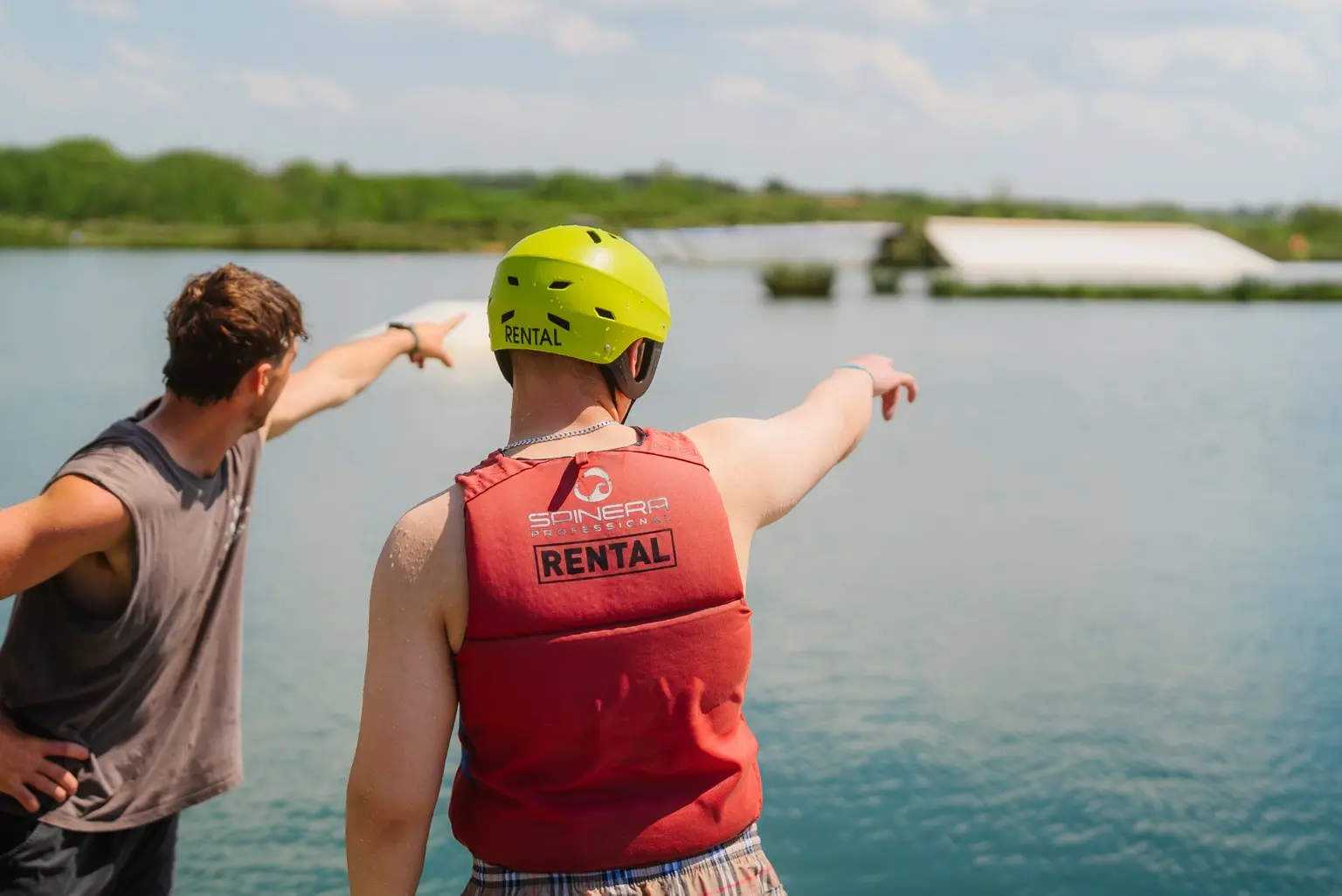 A North Devon Wake Park instructor briefing a customer beside the lake